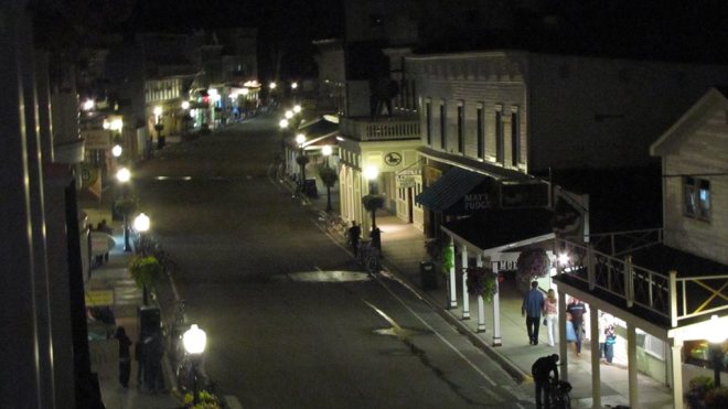 A nighttime view of Main Street from Bud & Hilde's balcony room at Main Street Inn & Suites.