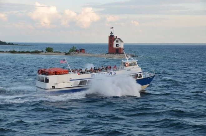 A loaded Shepler's boat passing Round Island Light on its way back to the mainland.  (Photo:  John Rice)