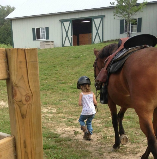 Little six-year-old Anna, a member of the island Giddy-Up-and-Go program, leads Fiona back to the barn.  (Photo: Leanne Brodeur)